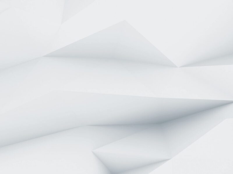 Un fond abstrait blanc et gris clair avec des formes géométriques angulaires et des ombres douces.