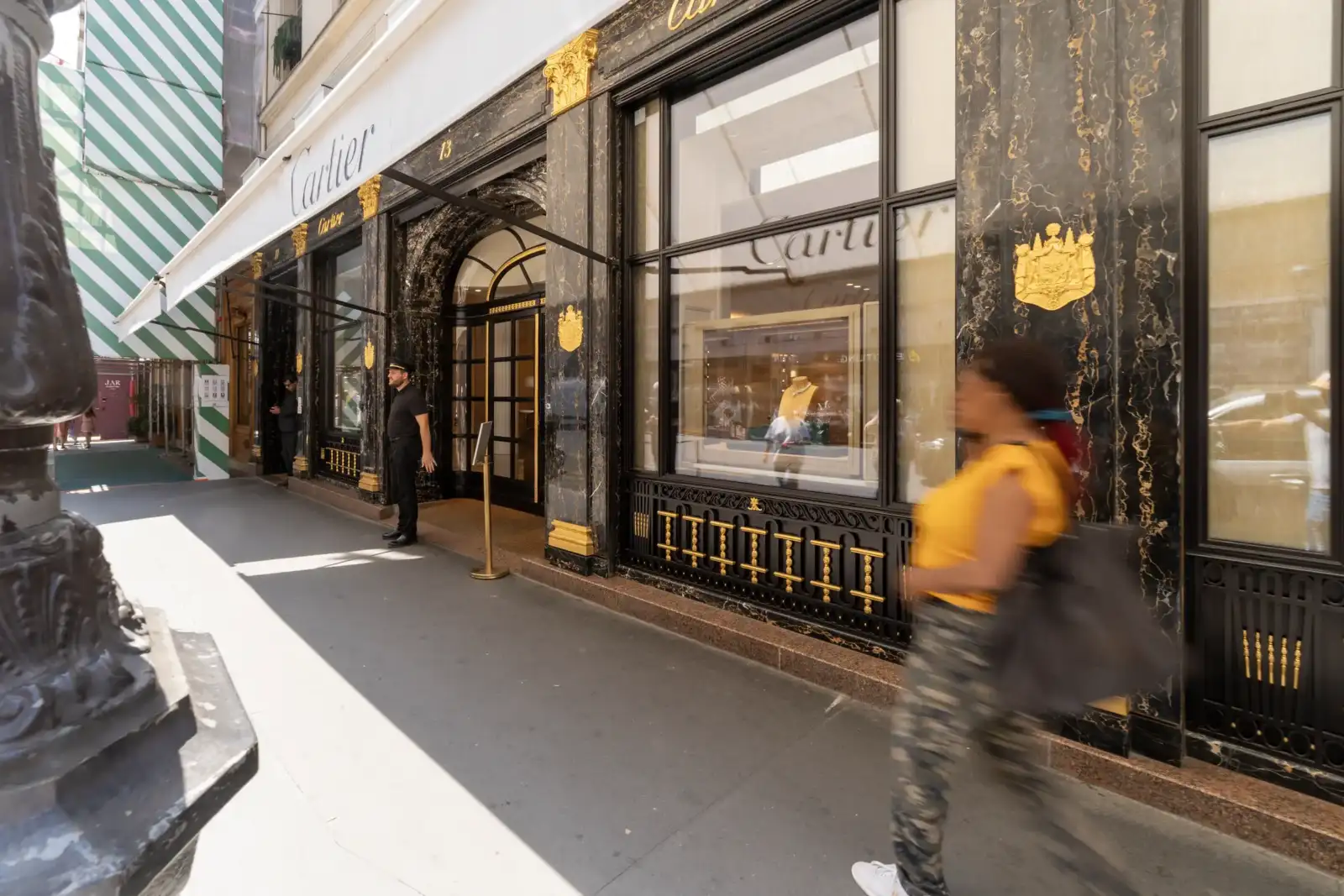 Façade élégante de la boutique Cartier à Paris avec marbre noir et finitions dorées.