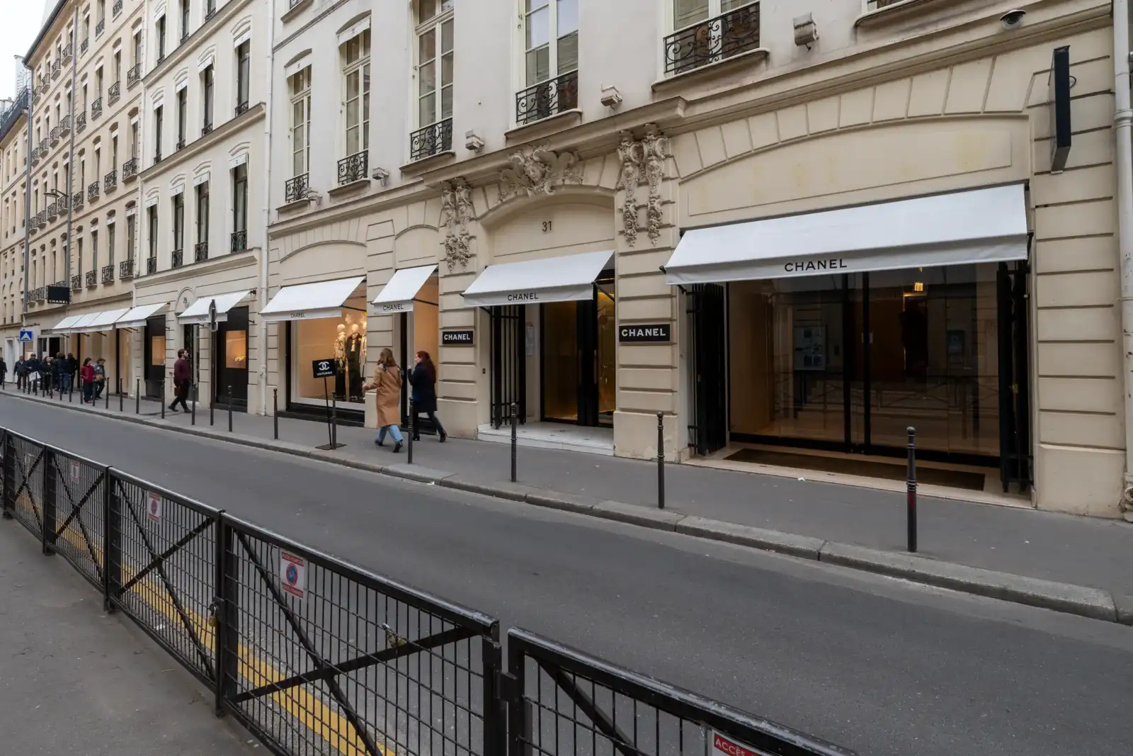 Façade élégante de la boutique Chanel située dans une rue historique de Paris.