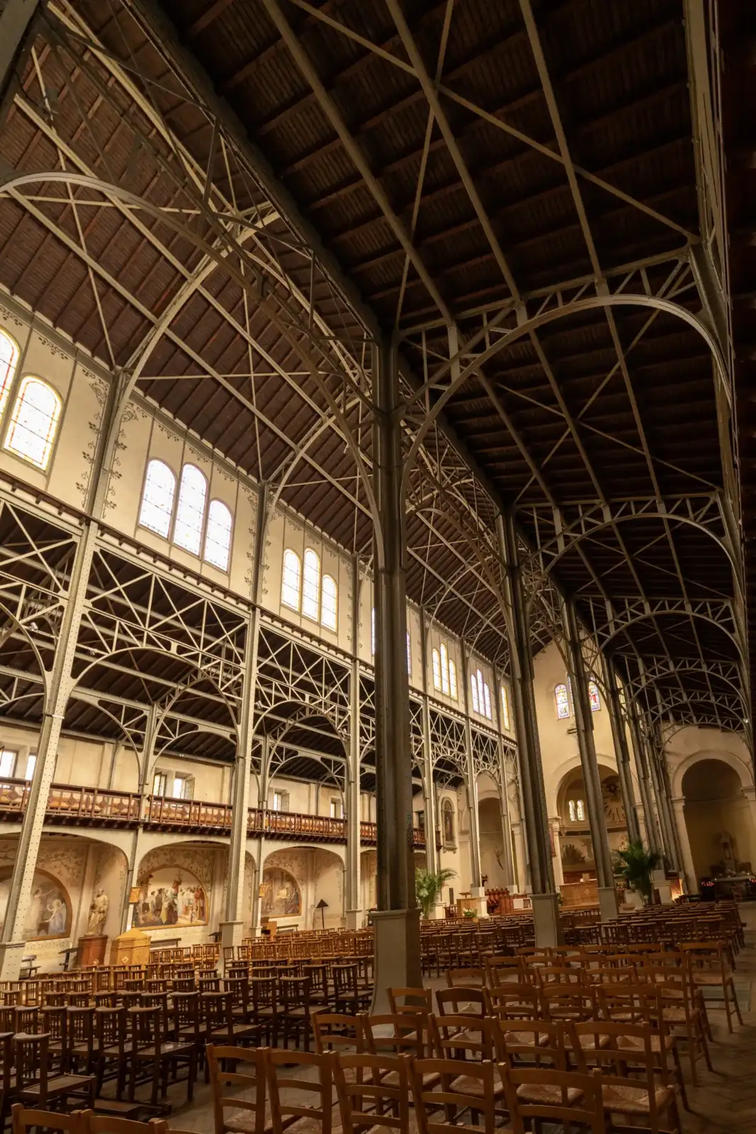 Vue intérieure de l'église Notre-Dame-du-Travail à Paris, montrant sa structure métallique apparente.