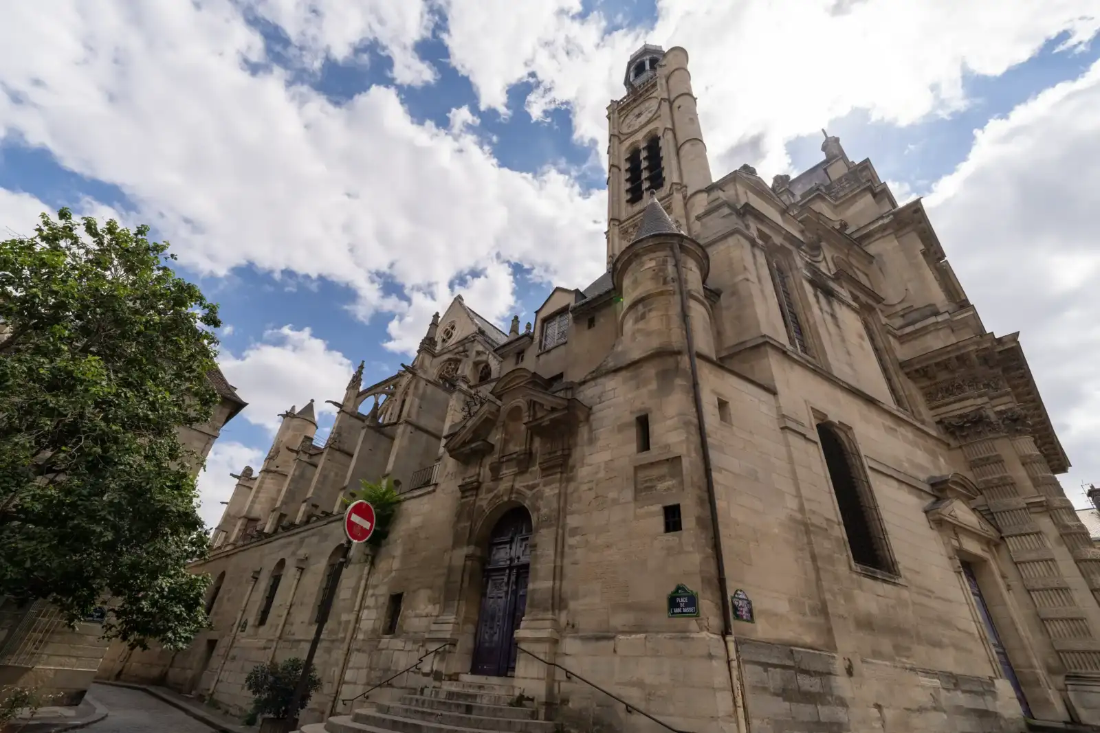 Vue en contreplongée de l église Saint Etienne du Mont à Paris sous un ciel nuageux.