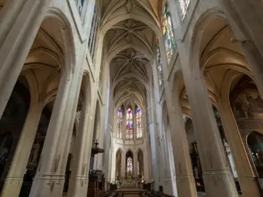 Vue en contre-plongée de la nef gothique et des vitraux de l'église Saint-Gervais-Saint-Protais à Paris.