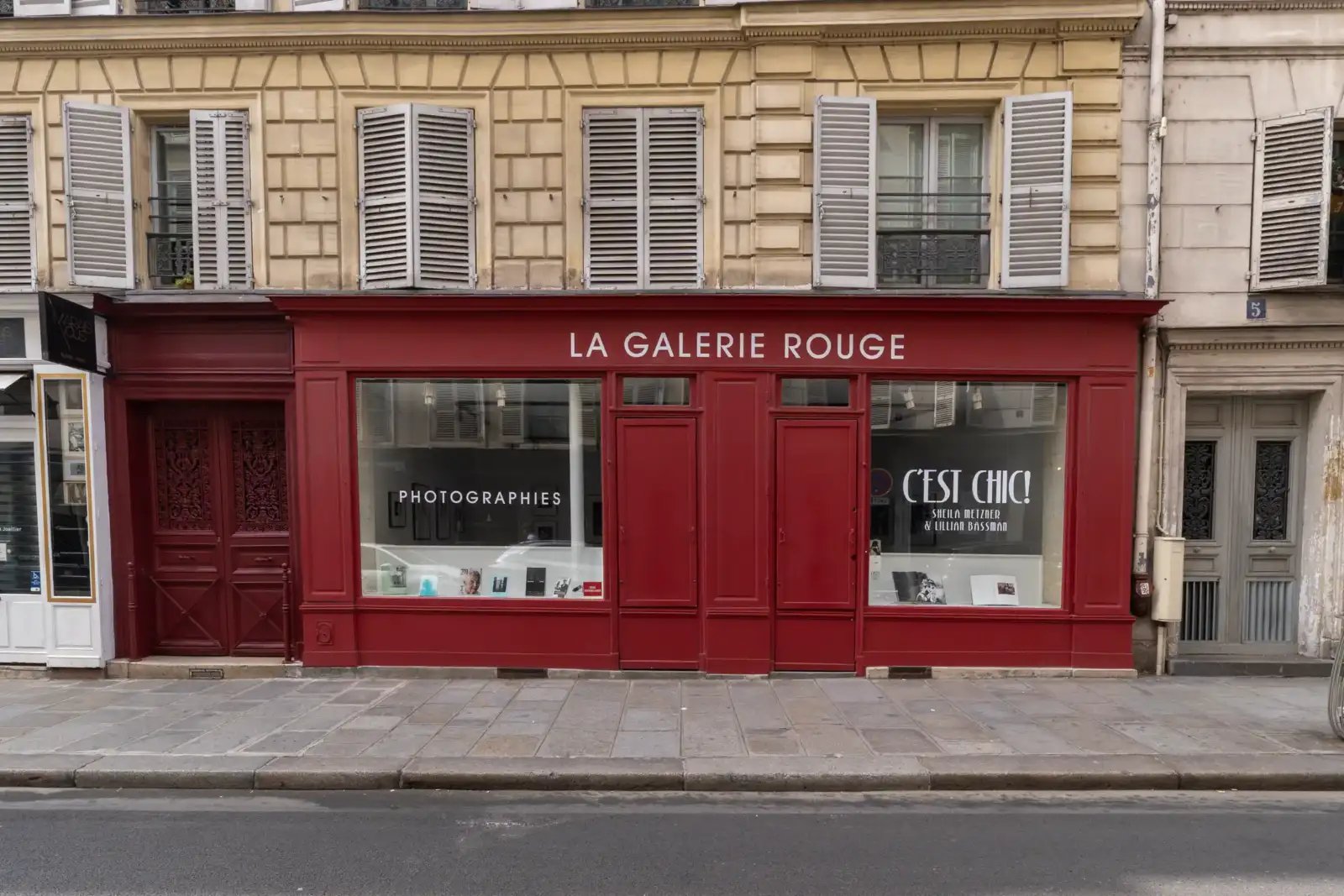Facade de la galerie rouge à Paris avec une devanture bordeaux et des vitrines.