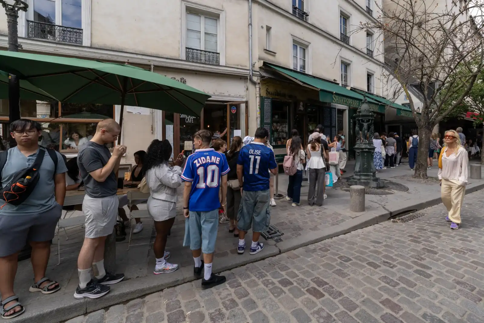 Une longue file de clients attend patiemment devant la librairie parisienne Shakespeare and Company.