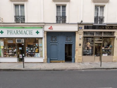 La façade du MAIF Social Club entre une pharmacie et une boutique à Paris.