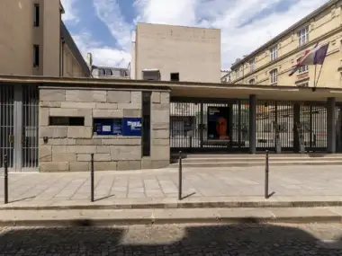 Façade en pierre du mémorial de la Shoah à Paris sous un ciel bleu.